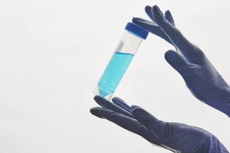 Close-up of unrecognizable medical researcher in protective gloves measuring dose of vaccine using...