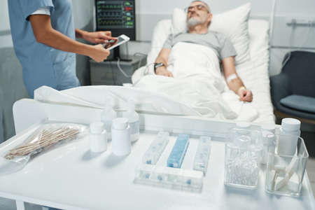 Selective focus on foreground shot of various meds and tools prepared for patients in emergency roomの写真素材
