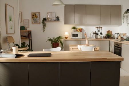 Horizontal image of modern domestic kitchen with big table and other kitchen utensilsの写真素材