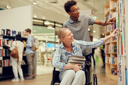 Smiling young Afro-American bookstore asking person with disability girl in wheelchairの写真素材