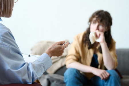 Psychologist giving an advice to patient during psycho consultation in officeの写真素材