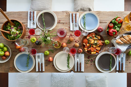 Dining table with salad and vegetablesの写真素材