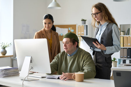Group of business people discussing online presentation on computer during teamwork in officeの写真素材