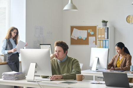 Group of colleagues working at their workplaces in modern officeの写真素材