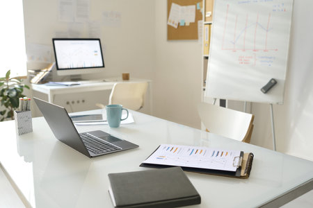 Workplace of business person with laptop and documents in modern officeの写真素材