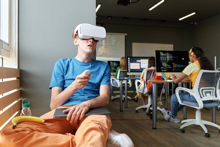 Student using VR glasses while sitting at lesson in the classroomの写真素材