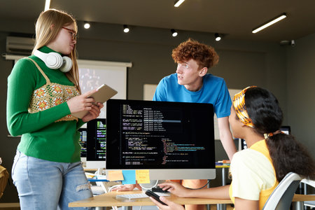 Group of students working over software on computer in team in the classroomの写真素材