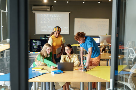 Teacher teaching information technology to students in the classroom at schoolの写真素材