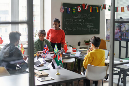 Group of students cooperating with teacher in the classroom at schoolの写真素材