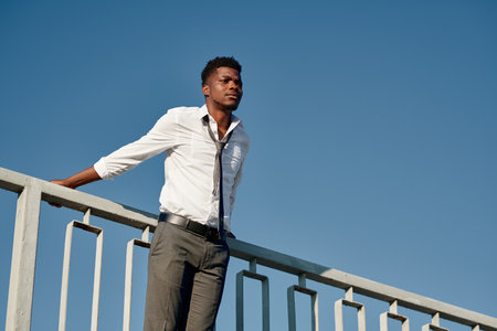 African American young man standing on the bridge and trying to commit suicideの写真素材