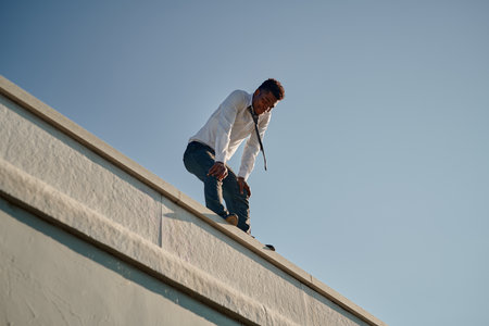 African American man in depression trying to commit suicide on the roofの写真素材