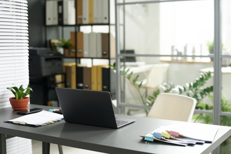 Modern workplace of manager with laptop and documents in modern officeの写真素材