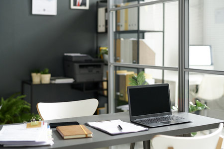 Workplace of social worker with documents and computer in modern officeの写真素材