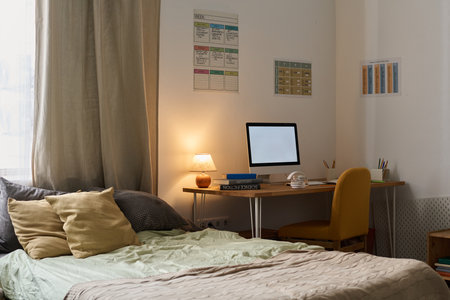 Modern room of teenager with bed and computer on deskの写真素材