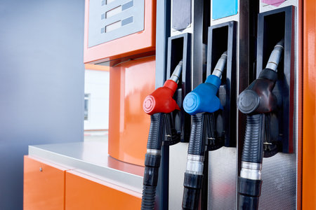 Close up background image of fuel pump with several nozzles in gas station, copy spaceの写真素材