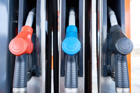 Close up of several fuel pump nozzles in row at gas station, copy spaceの写真素材