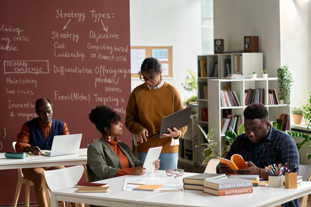 Group of African American college students working together in college classroom copy spaceの写真素材