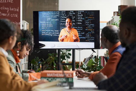 Black woman as professor on computer screen giving online class via remote technology to group of studentsの写真素材