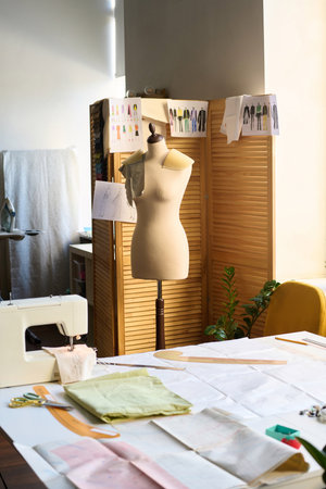 Vertical background image of atelier workshop interior with mannequin and sewing machine copy spaceの写真素材