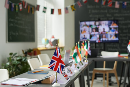 Background image of school classroom set up for international conference with country flags on tables, copy spaceの写真素材