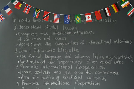 Front view background image of blackboard with terms of international peace and unity decorated by flags, copy spaceの写真素材