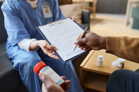 Close up of unrecognizable African American man signing medical form on clipboard during at home doctors visit copy spaceの写真素材