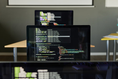 Computers with code lines on screen in modern IT classroom, copy spaceの写真素材