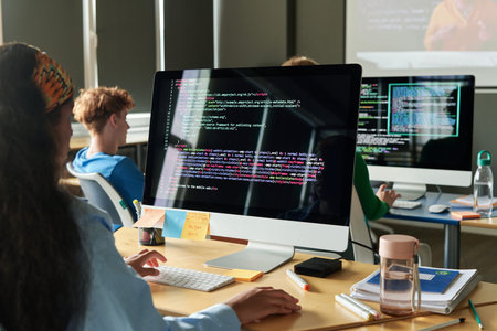 Students writing computer code during programming class in school or college, copy space