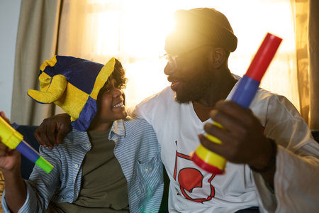 Happy moment featuring father and son playing together, sharing joyful expressions. Vibrant and relaxed ambiance with family interaction, both engaging with colorful toysの写真素材