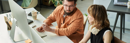 Caucasian young adult man discussing neural network development with Caucasian young adult woman at...