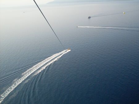 boat and a speedboat parachute dragging photoの写真素材