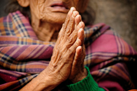 Bhaktapur, Nepal, Very old woman begging on the stairs of a Buddhist temple