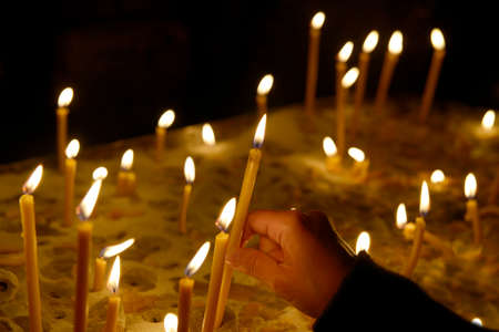 Lighting candles in the templeの写真素材