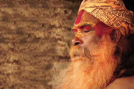 Kathmandu, Nepal, August 22, 2010. Sadhu staring at Pashupatinath Temple in Kathmanduのeditorial素材