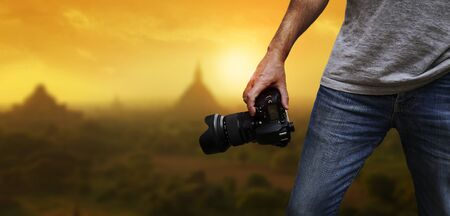 Photographer taking pictures in the middle of natureの写真素材