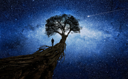 Man under a tree in front of the universe
