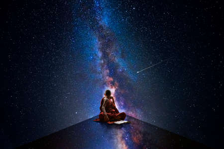 Buddhist monk looking at the universeの写真素材