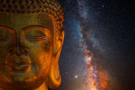 Golden head of Buddha with milky way in the backgroundの写真素材