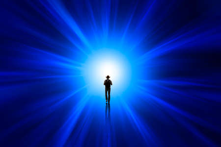Man walking towards the lightの写真素材