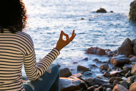 Beautiful woman doing yoga at the beachの写真素材
