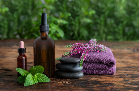 Spa still life with essential oil and aromatic herbs on wooden backgroundの写真素材