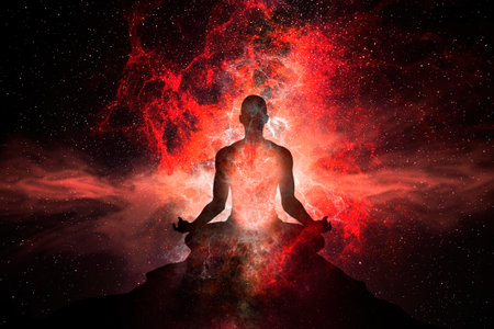 Man meditating in the lotus position on a background of red nebulaの写真素材