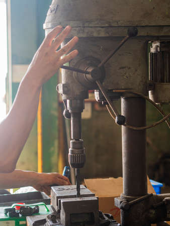 MECHANIC MAKING REPAIRS IN THE WORKSHOPの写真素材