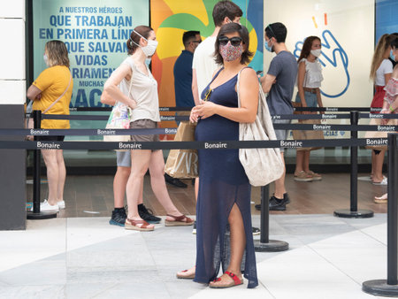ALDAYA, VALENCIA / SPAIN; JULY 7, 2020; MAKING SOCIAL DISTANCE TO ENTER A STORE