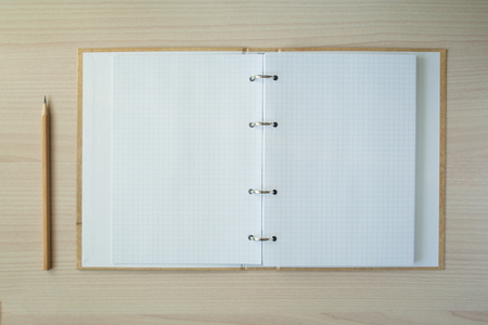 Pencil with open clear notepad on wooden table
の写真素材