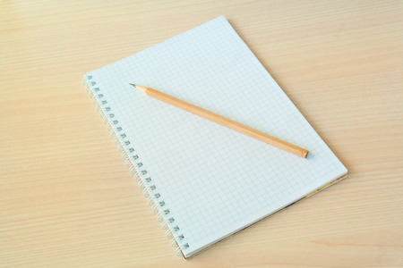 Pencil with open clear notepad on wooden table
の写真素材
