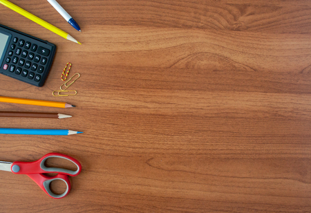 Stationery on wooden table with calculator backgroundの写真素材
