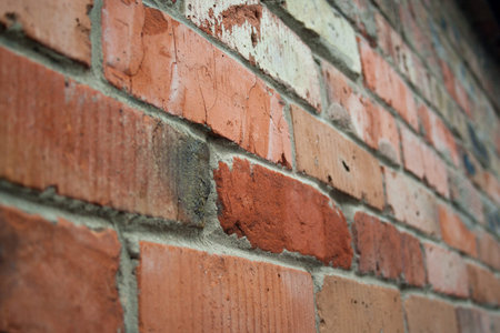 Destroyed brick wall of red bricks, texture