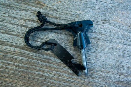 Flint and a brace tied with cord on a wooden backgroundの写真素材