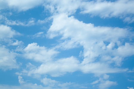 Huge clouds in blue sky lit by the sun, not windyの写真素材